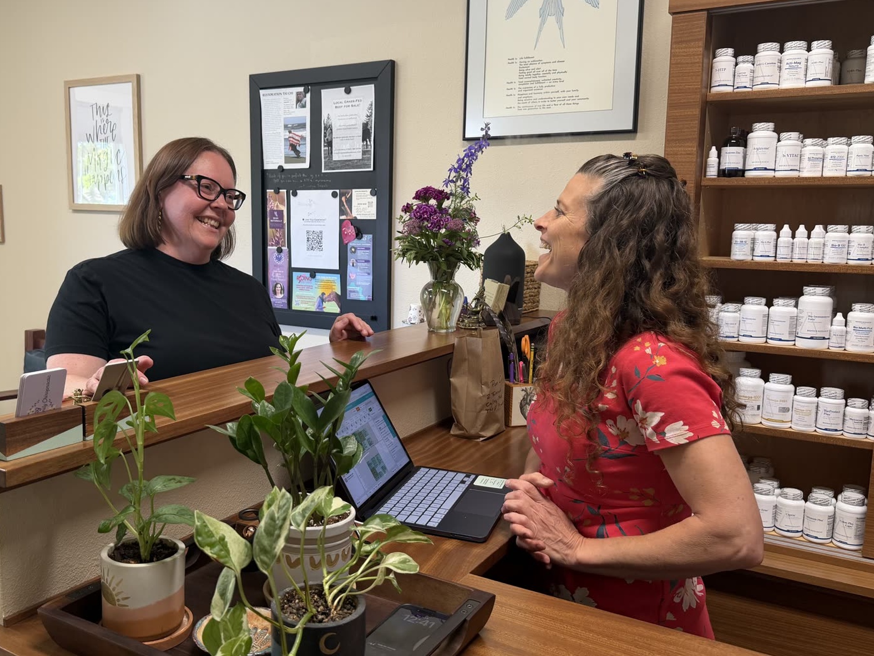 Dr. Hannah at the front desk welcoming a patient inside the Ashland office